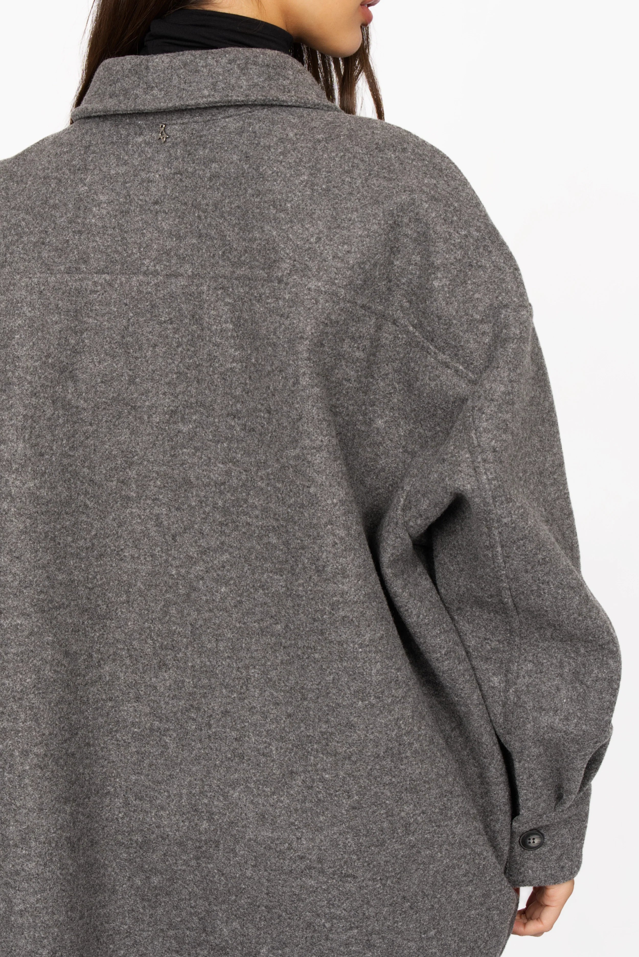 Back view of gray BJORA Overshirt in wool blend with oversized fit and buttoned cuff.