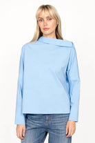 BONI asymmetrical one shoulder blouse in light blue with extended back and wide cuffs worn by model