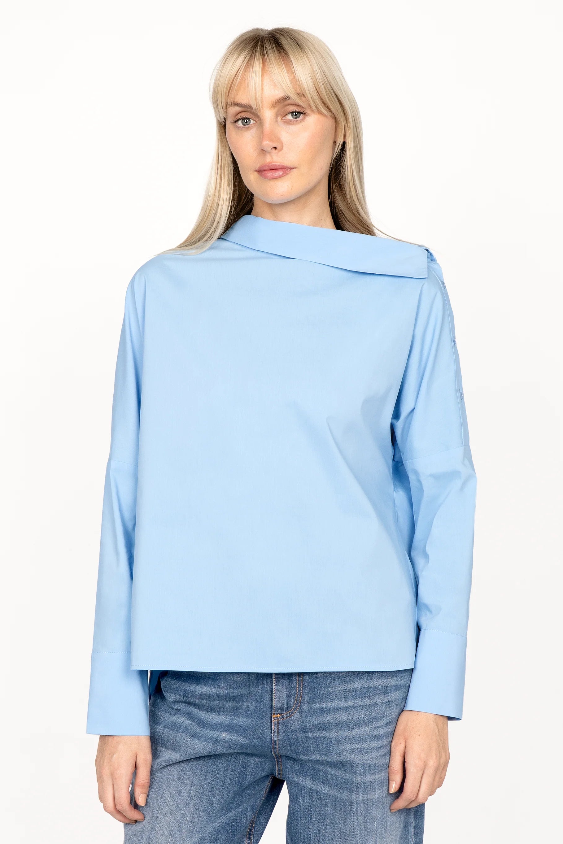 BONI asymmetrical one shoulder blouse in light blue with extended back and wide cuffs worn by model