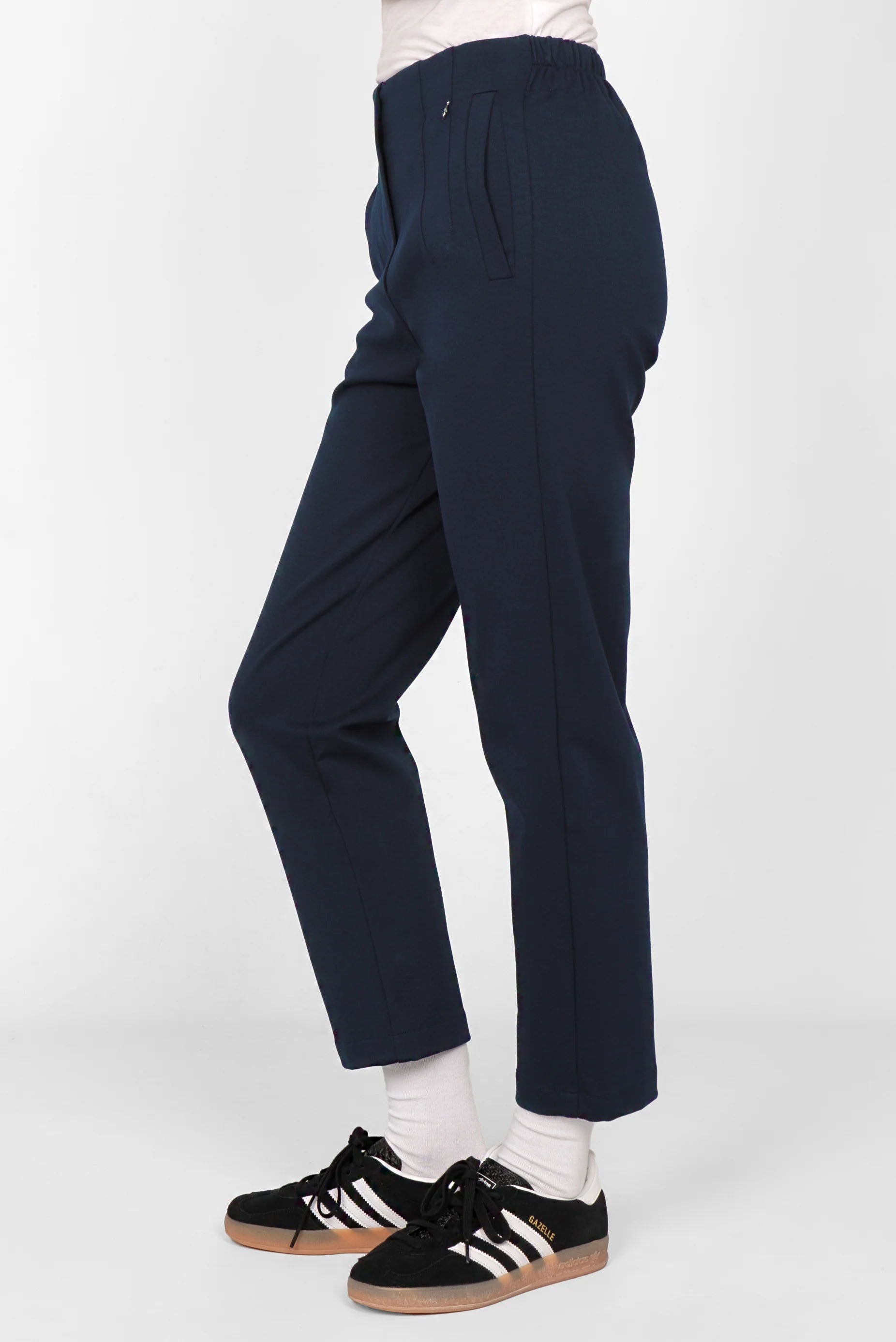 Navy blue CEELIA ankle pants with slim fit, elastic back waistband, side pockets, cropped length, and decorative stitching.