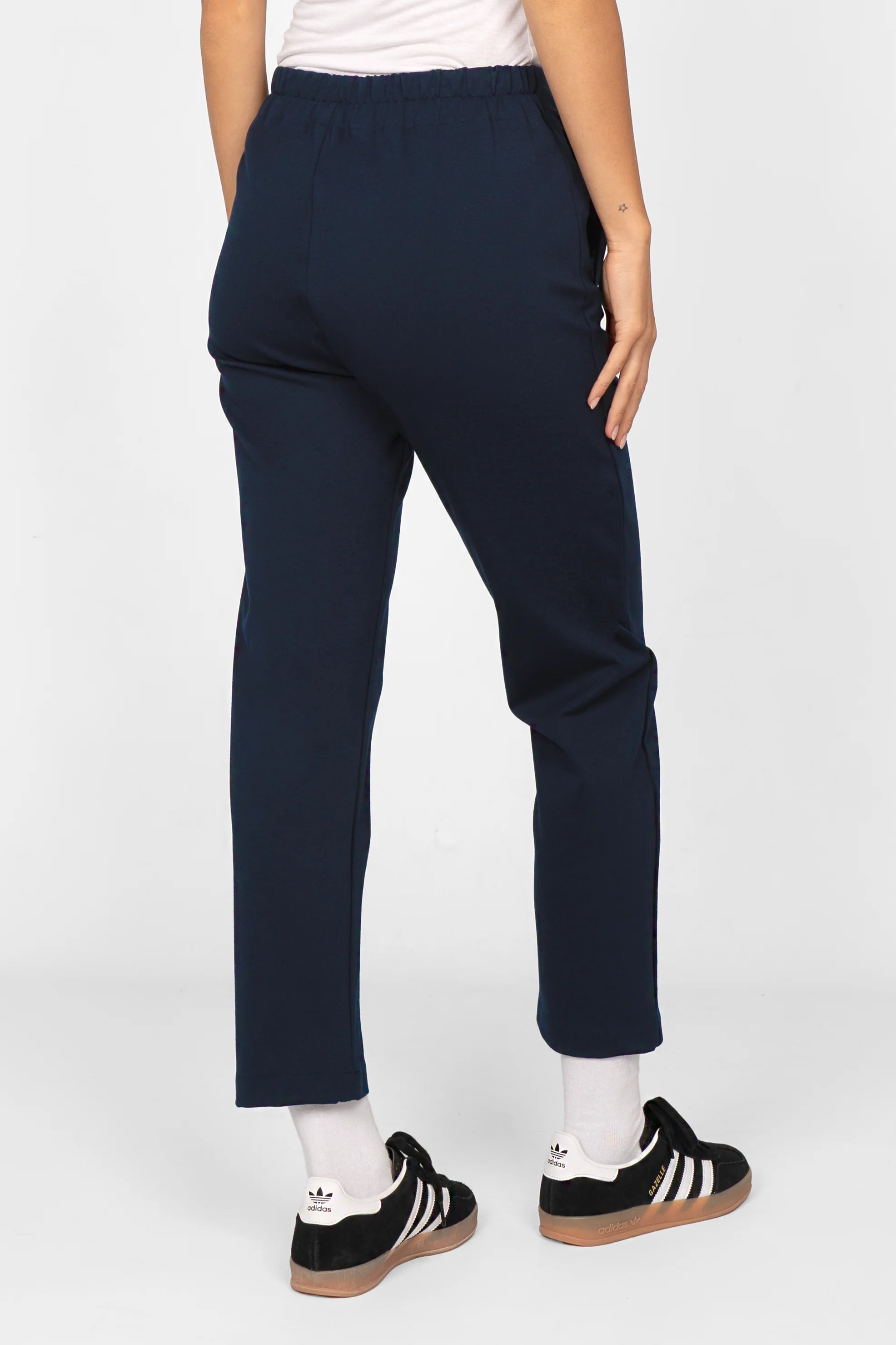 Navy blue slim-fit ankle pants with elastic high waist and cropped length.
