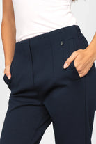 Close-up of navy blue CEELIA ankle pants with high waist, elastic back waistband, side pockets, and slim cropped fit.