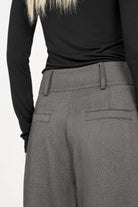 Back view of RYONI Marlene-Hose with high waist, wide leg, and structured herringbone fabric.