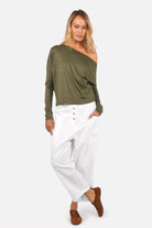 Woman wearing FRYA one shoulder longsleeve with asymmetrical neckline and batwing sleeves