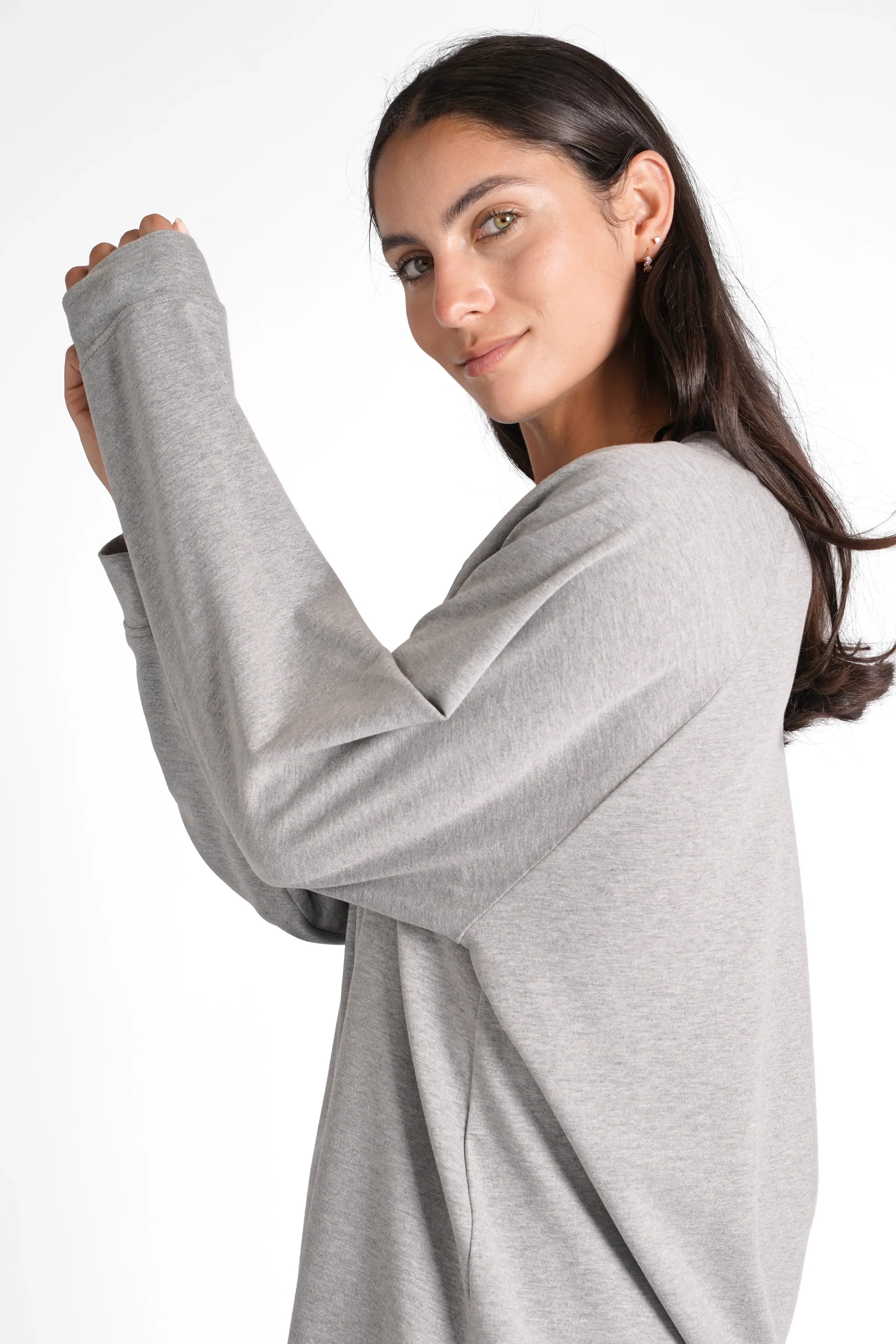 Woman wearing grey oversized GRACEY.K Sweater with A-line silhouette and tonal logo embroidery