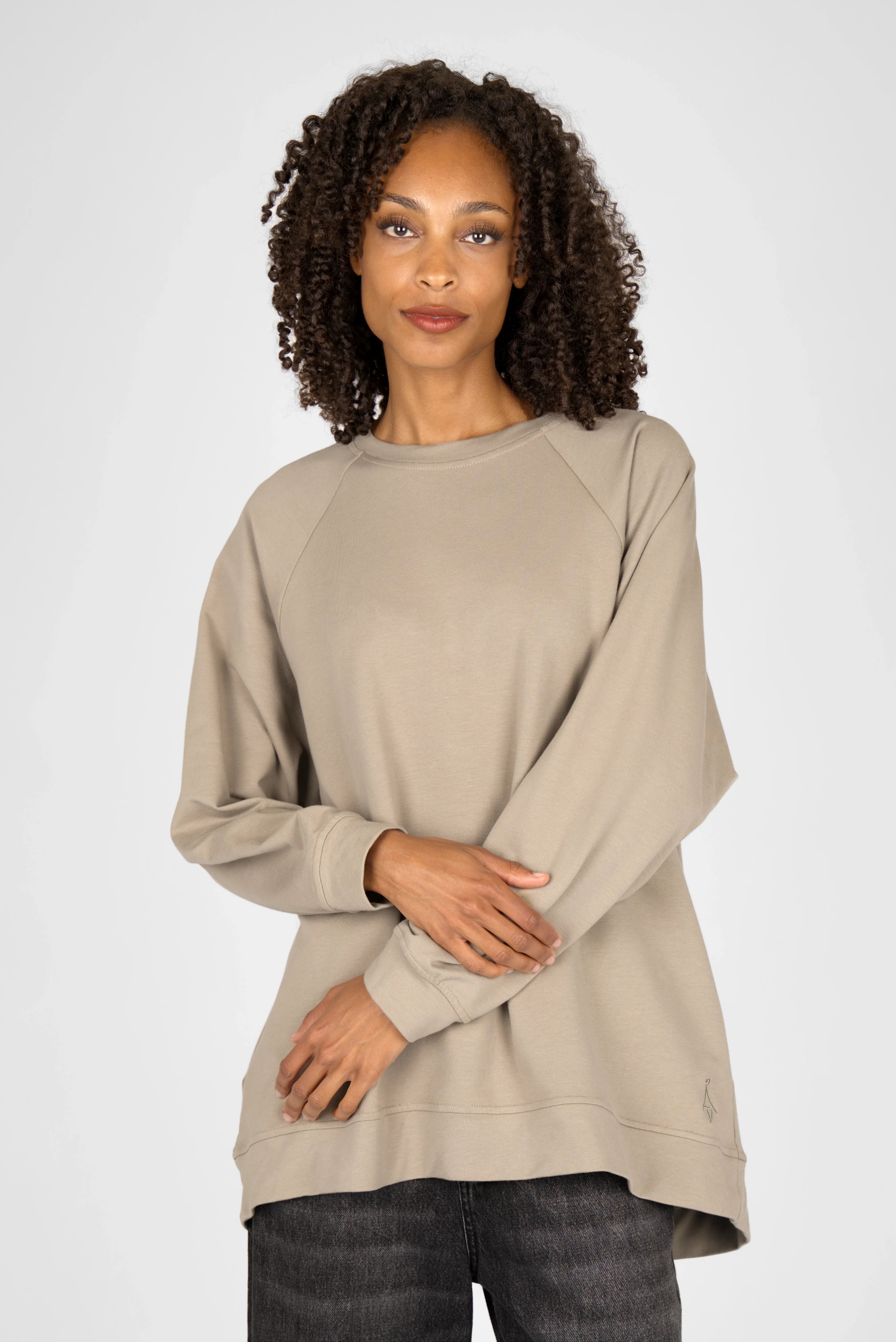 Woman wearing beige oversized GRACEY.K Sweater with round neckline and tonal logo embroidery