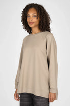 Woman wearing beige GRACEY.K Sweater with round neckline and oversized fit