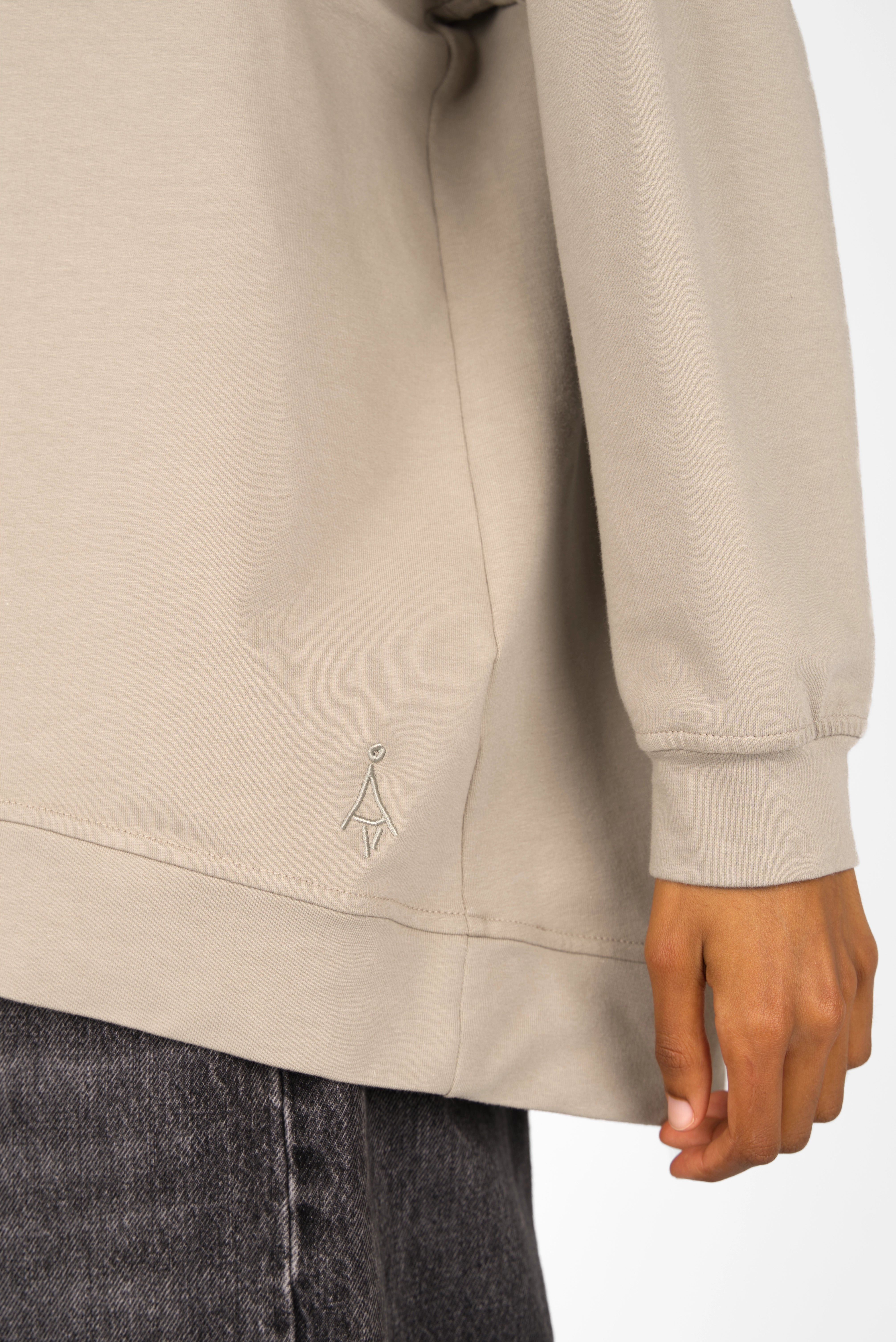 Beige GRACEY.K Sweater with tonal logo embroidery, rounded hem, oversized fit, and longer back silhouette.