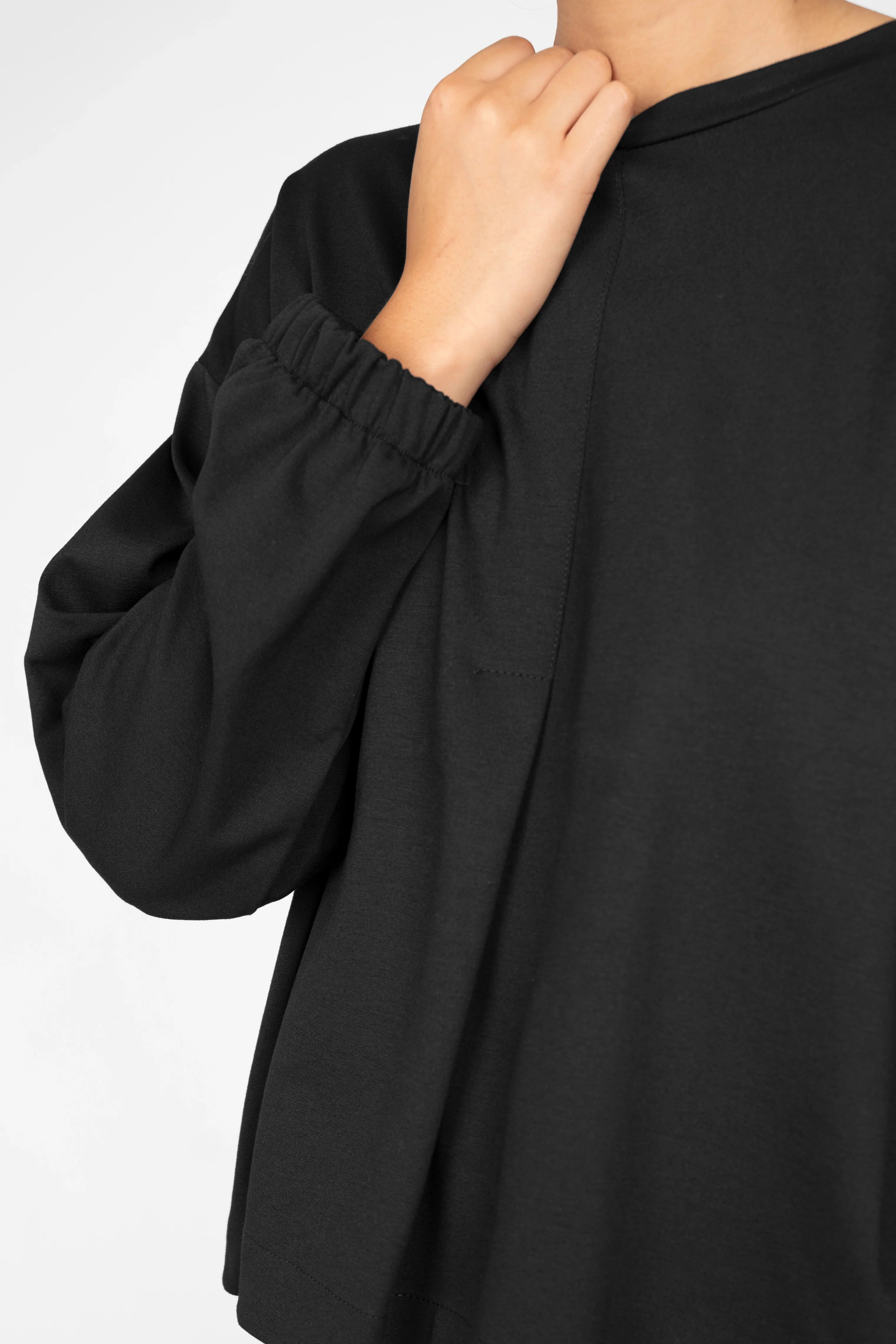 Close-up of black HAGLA Shirt made from heavy viscose blend with elastic cuffs and front stitched pleat detail
