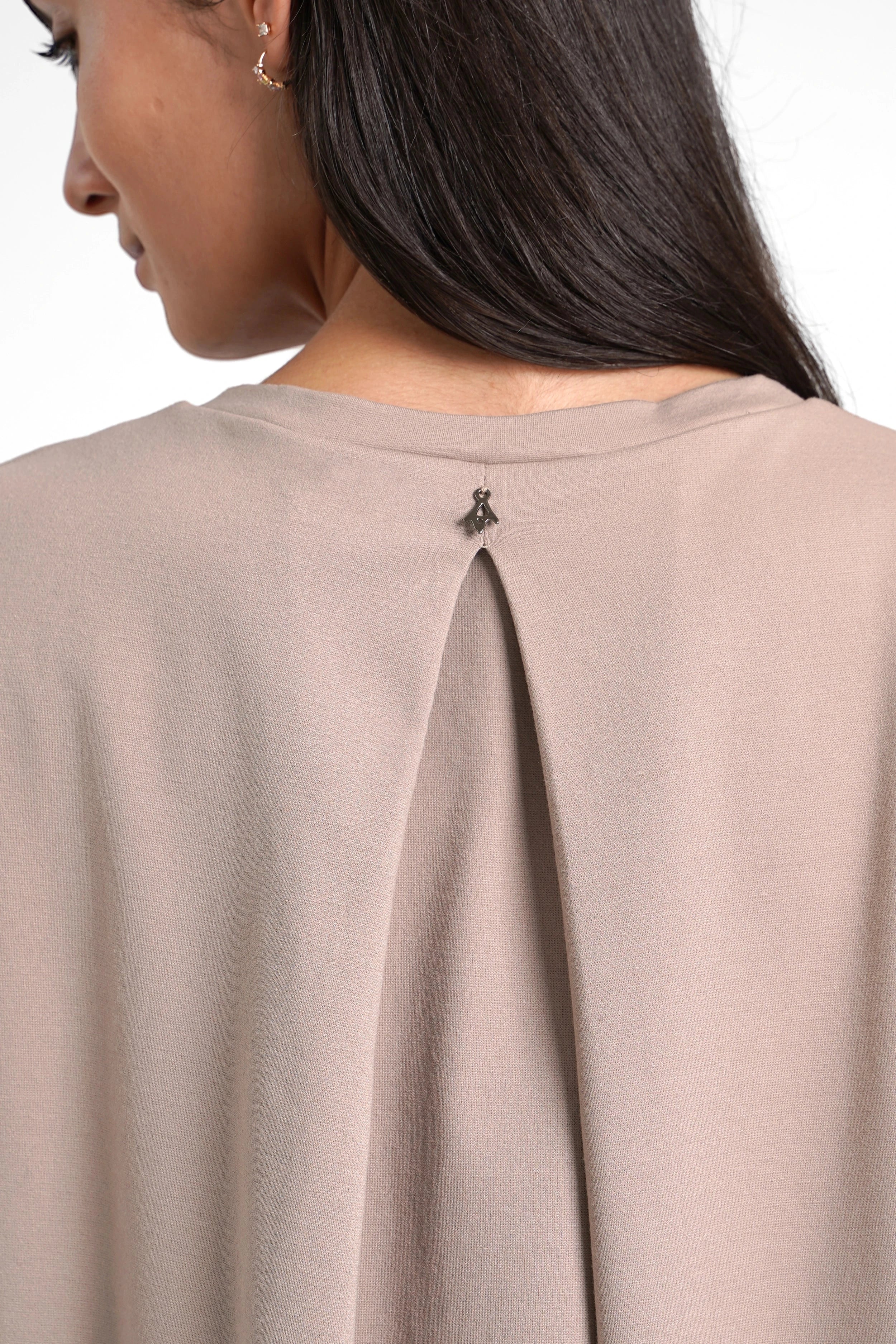 Close-up of the back of a taupe HAGLA Shirt featuring a subtle pleat and round neckline made from soft, wrinkle-free viscose blend fabric.