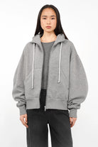 Gray relaxed fit zip-hoodie with oversized sleeves, kangaroo pocket, and drawstring hood