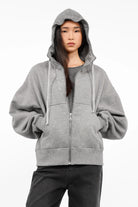Grey relaxed fit zip-hoodie with oversized sleeves, hood with drawstring, and kangaroo pocket