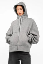 Gray relaxed fit zip-hoodie with hood, kangaroo pocket, and ribbed cuffs