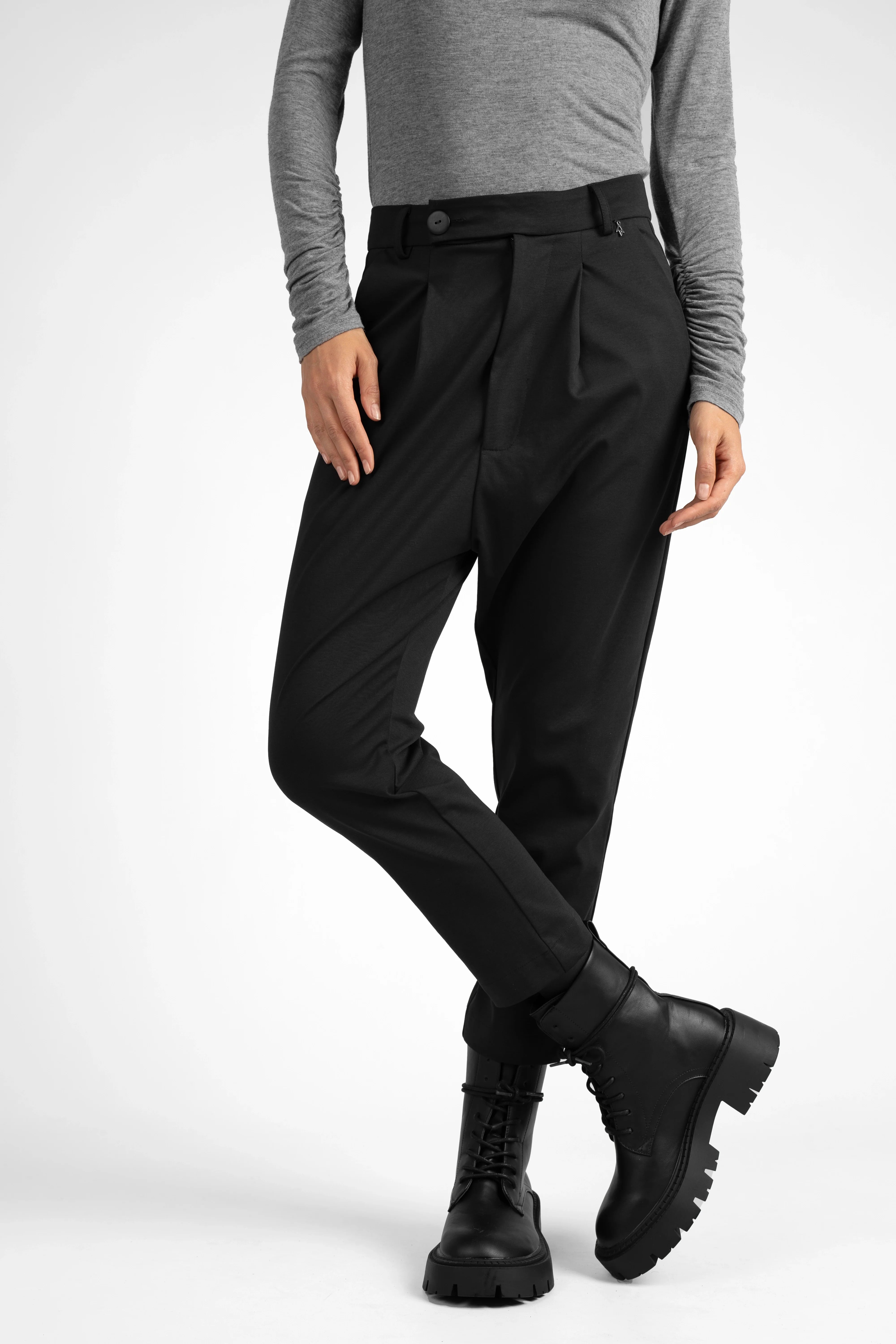 Black JALDI Cropped Tapered Hose with elastic back waistband and tapered leg, styled with casual boots