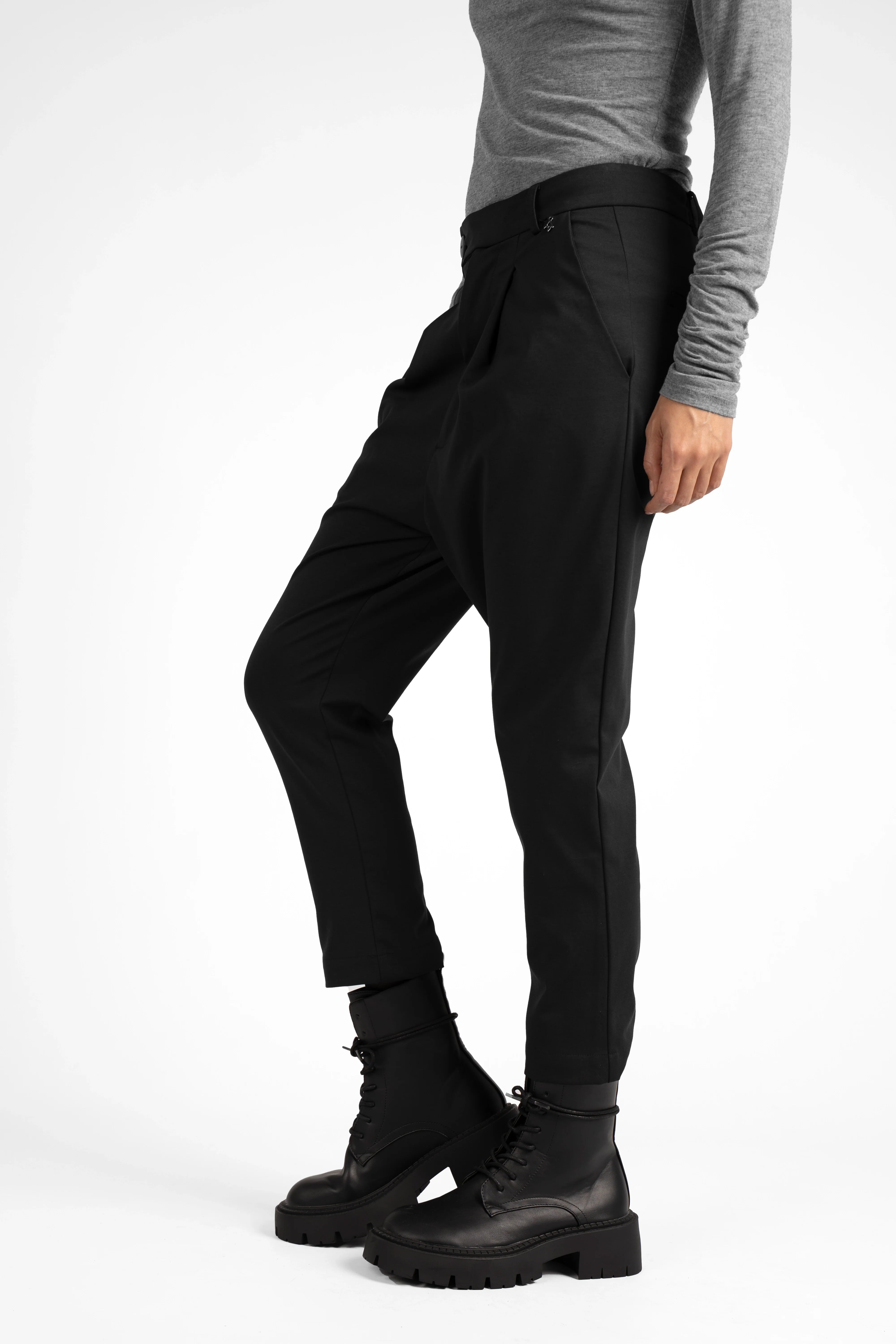 Black JALDI cropped tapered pants with elastic waistband and slim fit legs, modeled with boots and gray top
