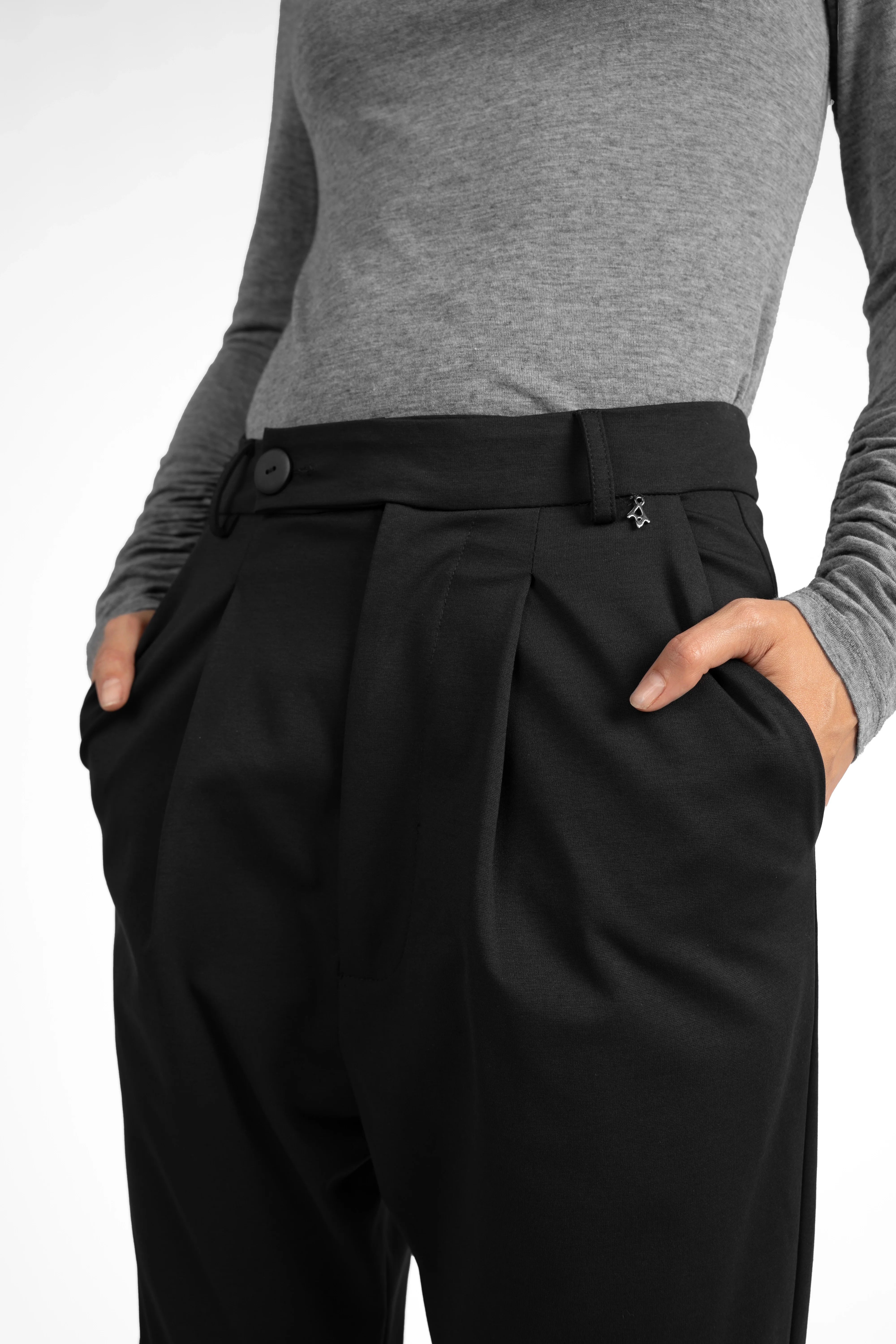Black JALDI cropped tapered pants with pleats and elastic waistband, styled with a gray fitted top