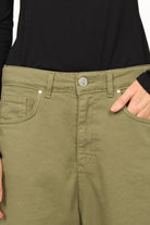 Olive green baggy jeans with relaxed fit and 5-pocket design, featuring a zip fly and button closure.