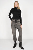 Woman modeling JEANY Baggy Jeans in gray washed denim with relaxed fit and slightly cropped legs