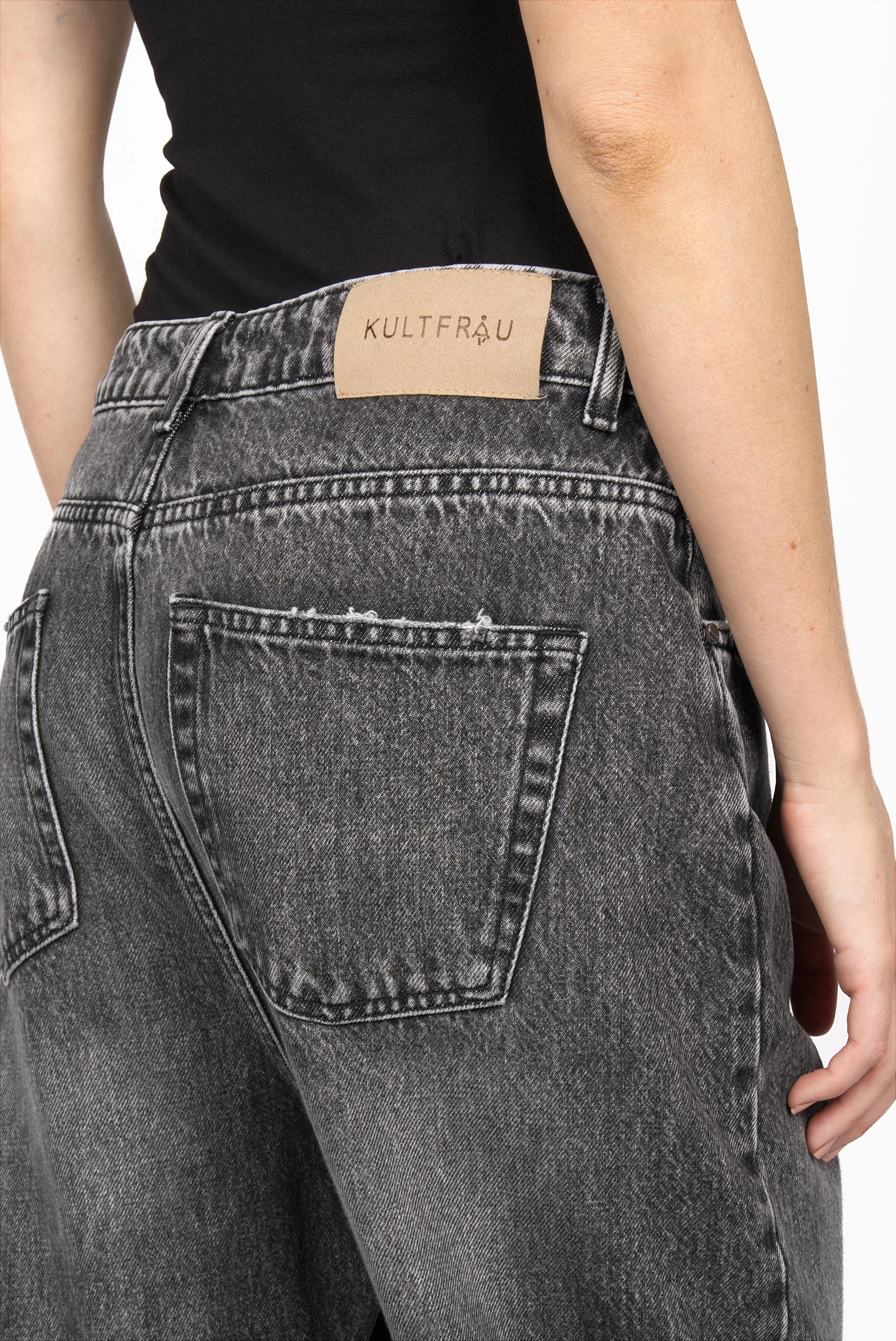 Black washed baggy jeans with relaxed fit, deep rise, wide cuff, and five pockets.