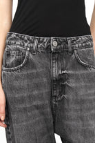 Black washed baggy jeans with relaxed fit, deep crotch, and wide fixed cuff detail.