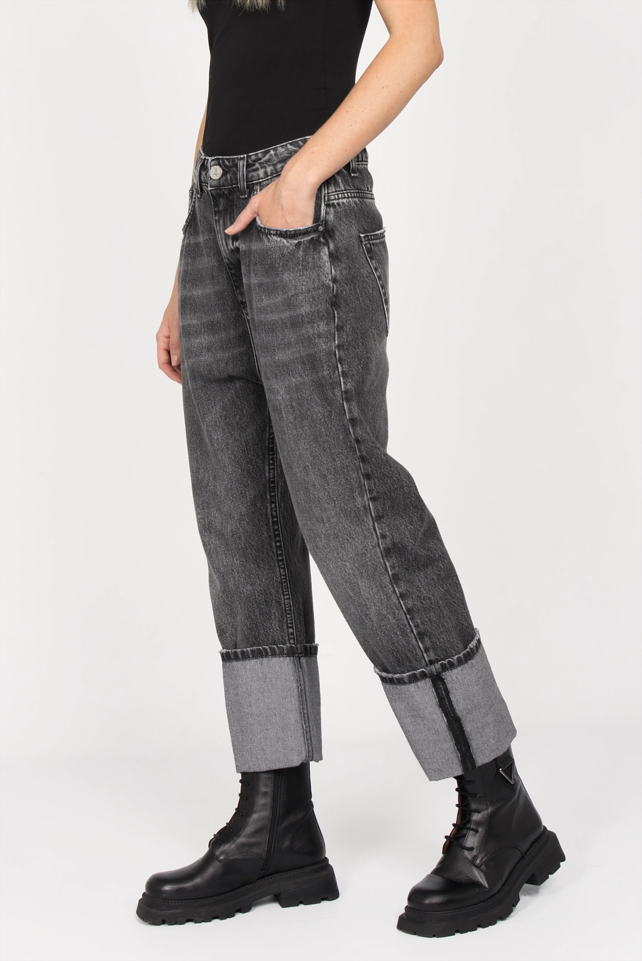 Black faded baggy jeans with wide cuff and relaxed fit worn with black boots