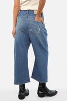 Model wearing Italian-made JENYA baggy jeans with destroyed wash and relaxed fit