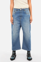 Woman wearing JENYA baggy jeans with destroyed wash and relaxed fit in light Italian denim