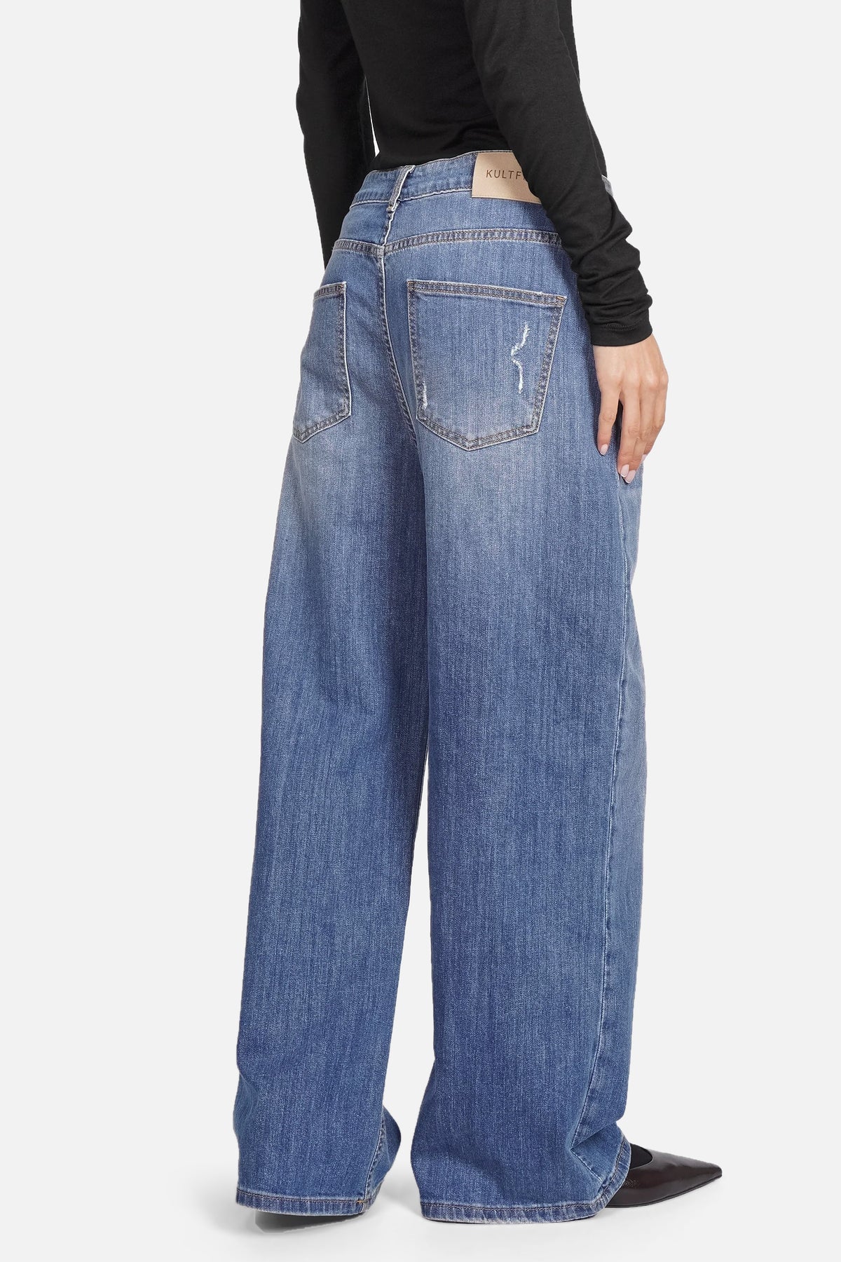JOOSY Wide Leg Jeans in medium blue with relaxed fit and wide straight legs, featuring subtle faded and worn details, made from soft, slightly stretchy denim.