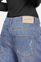 Vue de dos du jean large JOOSY en denim bleu moyen, à la coupe décontractée et aux effets usés discrets