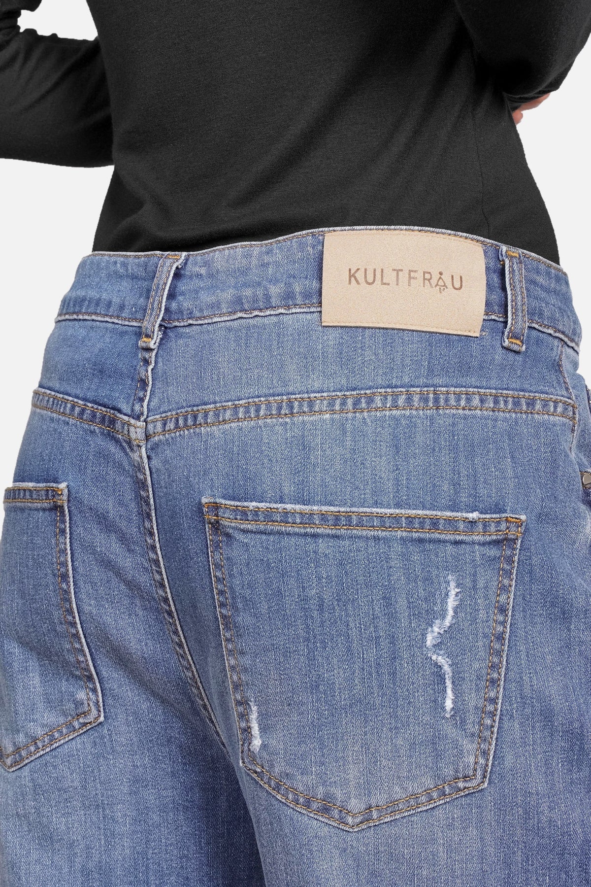 Back view of JOOSY Wide Leg Jeans in medium blue denim with relaxed fit and subtle distressed details