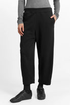 Model wearing black JOUDY Carrot Jogpant with elastic waistband and cropped carrot fit design