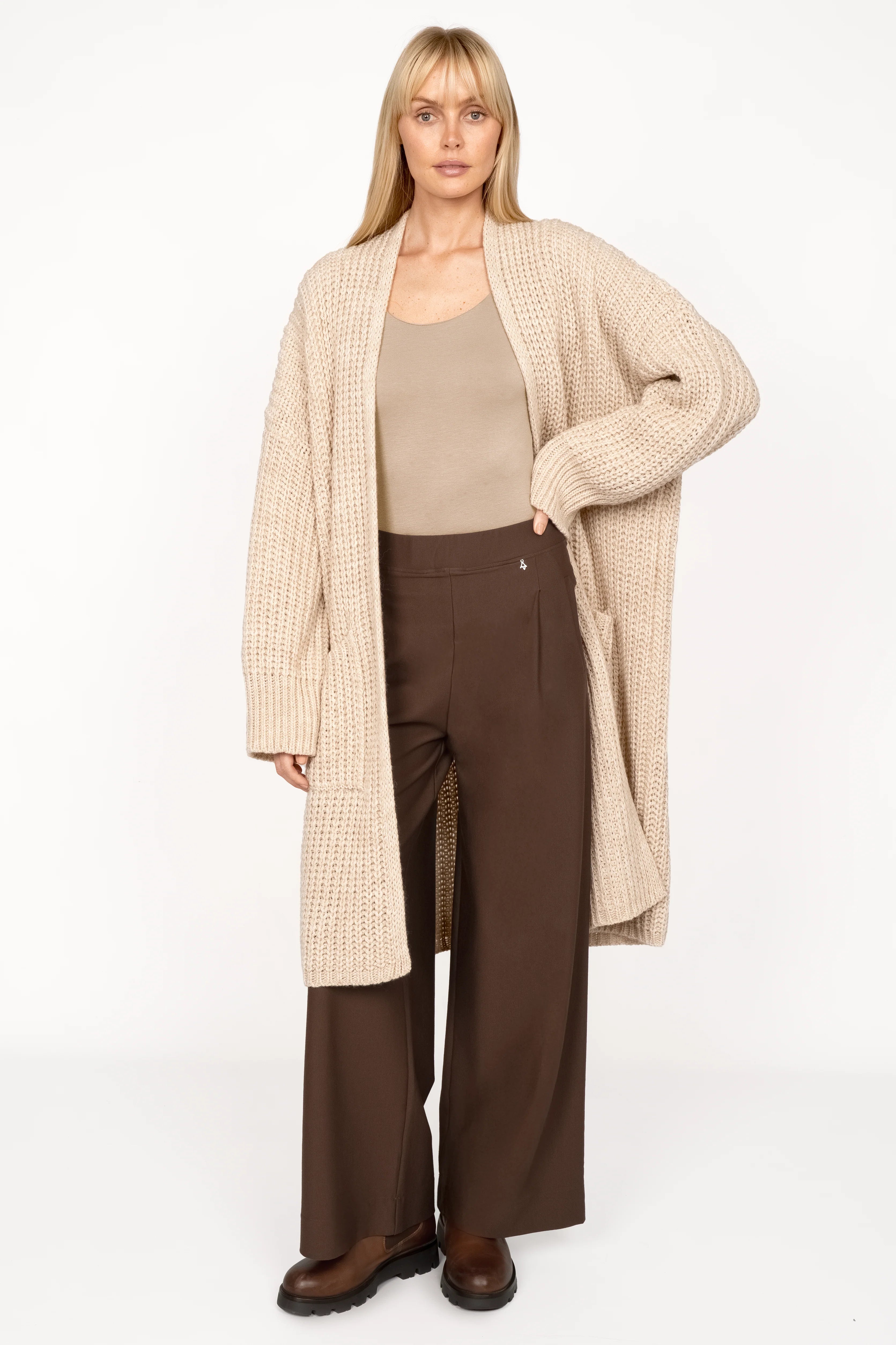 Woman wearing KLARA.K Wide Leg Pants in brown with beige knit cardigan and tank top