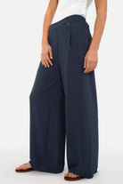 Woman wearing LARA.K Wide Leg Pants in lightweight, wrinkle-resistant fabric with elastic waistband and side pockets