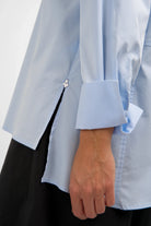 LEA.K Loose Fit light blue poplin blouse with wide button cuff and side slit detail