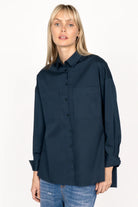Woman wearing navy blue LEA.K Loose Fit Bluse with chest pockets and buttoned cuffs
