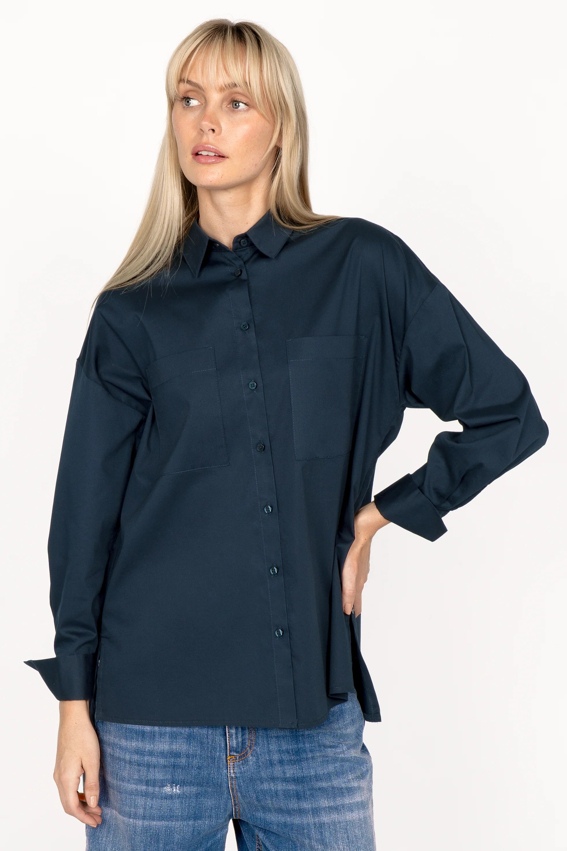 Woman wearing navy blue LEA.K loose fit blouse with long sleeves and button-up front