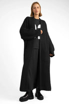 Black oversized LOLA Strickcardigan knit with open front, relaxed fit, and patch pockets worn by model