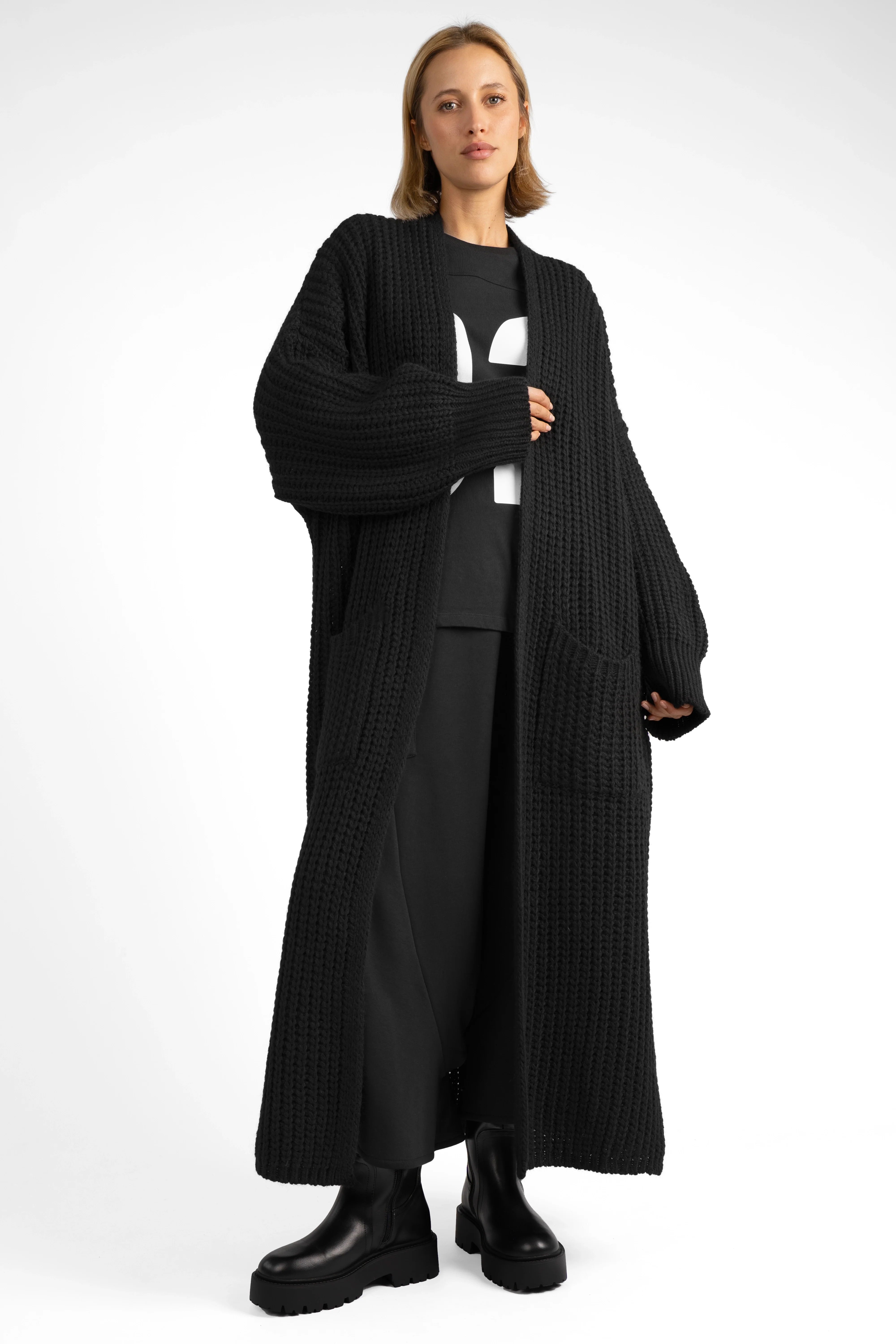 Black oversized LOLA Strickcardigan knit with open front, relaxed fit, and patch pockets worn by model