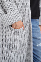 LOLA Strickcardigan close-up of soft gray knit fabric with pocket and rolled sleeve in relaxed oversized fit