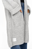 LOLLYTA Strickcardigan oversized grey knit cardigan with front pockets and rolled sleeves worn with jeans