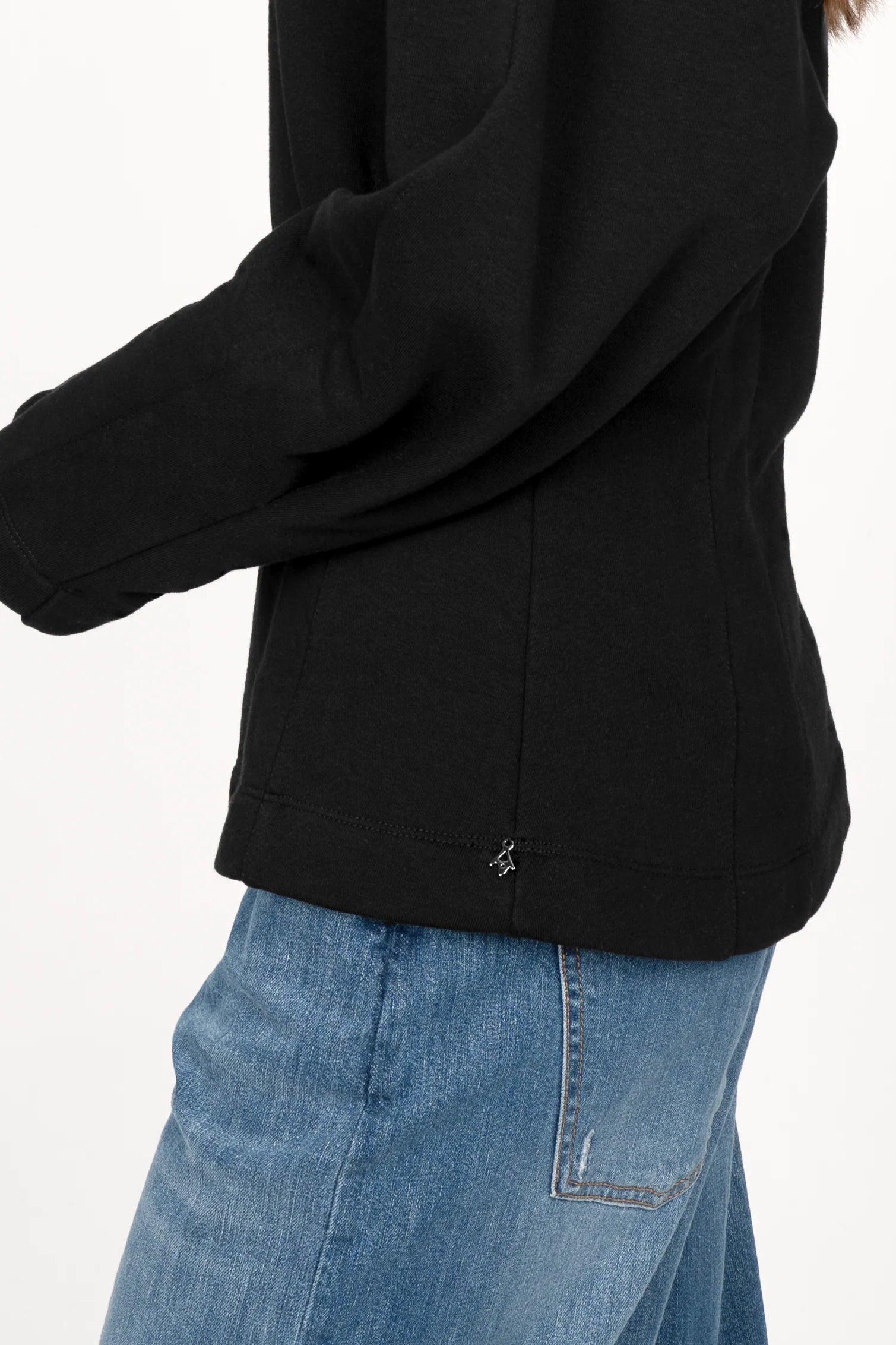 Black MALVEA Sweater with relaxed fit and structured seam details, worn with blue jeans.