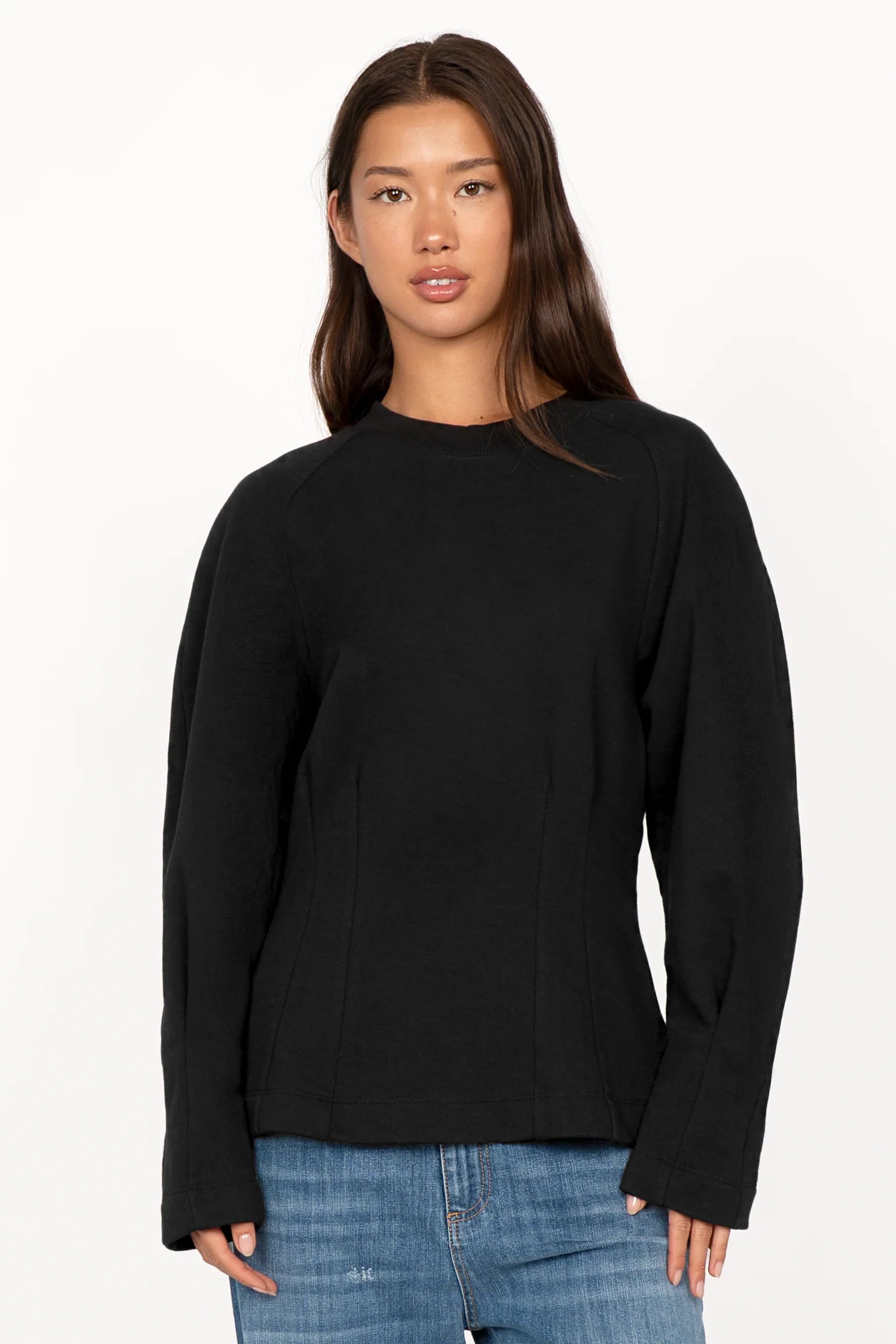 Black MALVEA Sweater with structured seams and relaxed fit worn by woman
