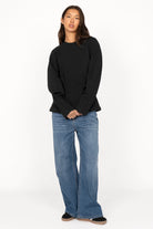 Schwarzer MALVEA Sweater mit formgebenden Teilungsnähten und relaxed Fit aus Baumwollmischung, getragen von Frau mit blauen Jeans.