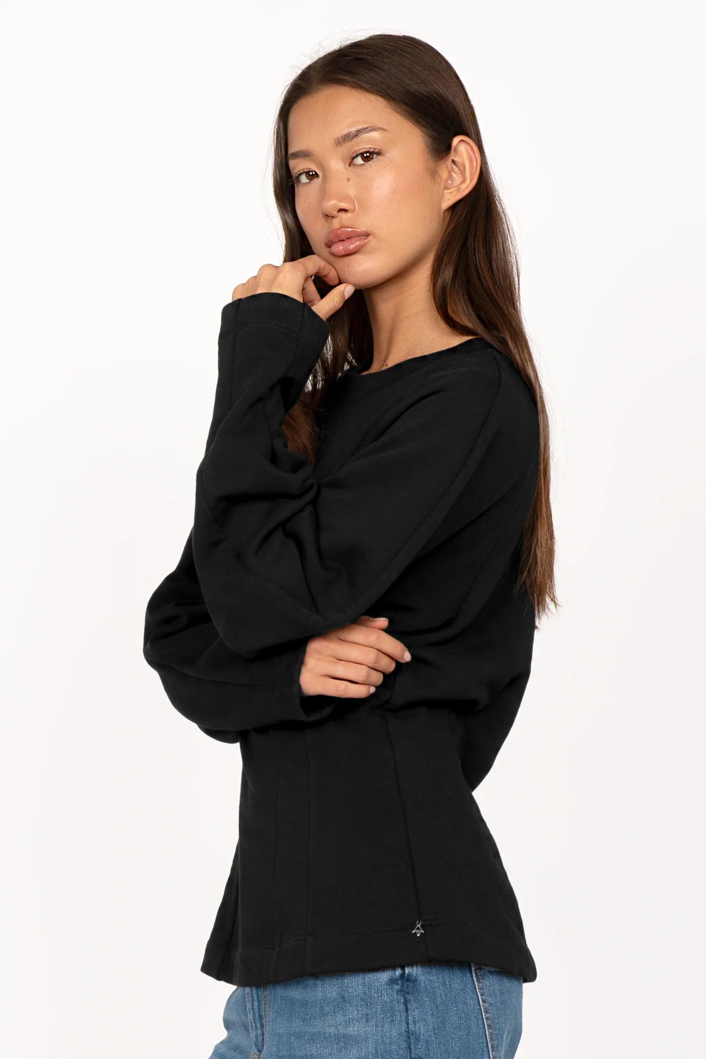 Black MALVEA Sweater with relaxed fit, rounded neckline, and detailed seam lines on model