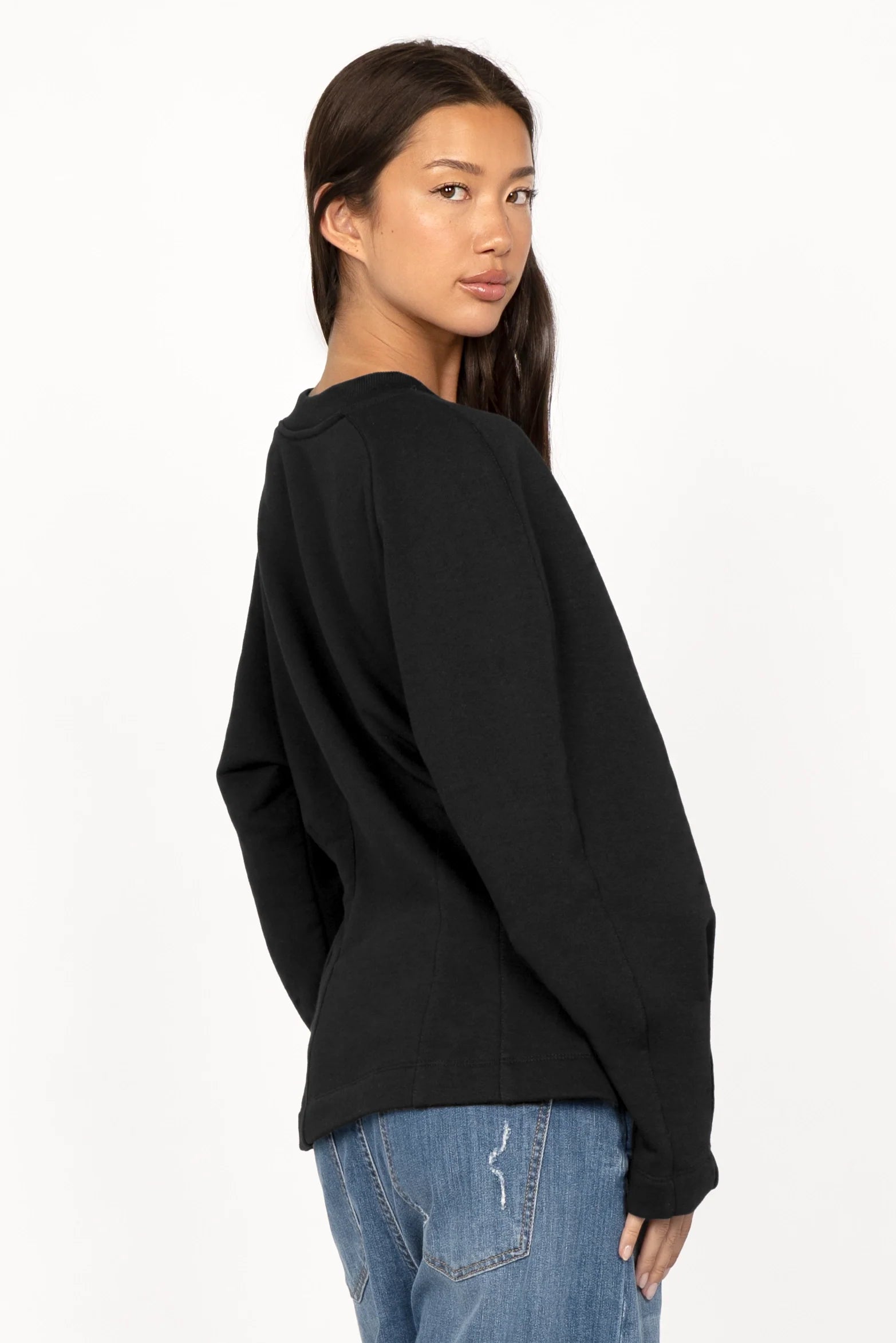 Frau trägt schwarzen MALVEA Sweater mit Teilungsnähten und Relaxed Fit aus Baumwollmischung.