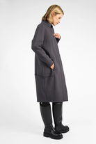 Woman wearing a dark gray MANEY Sweatmantel with brushed inner jersey, concealed button placket, and slightly longer back hem