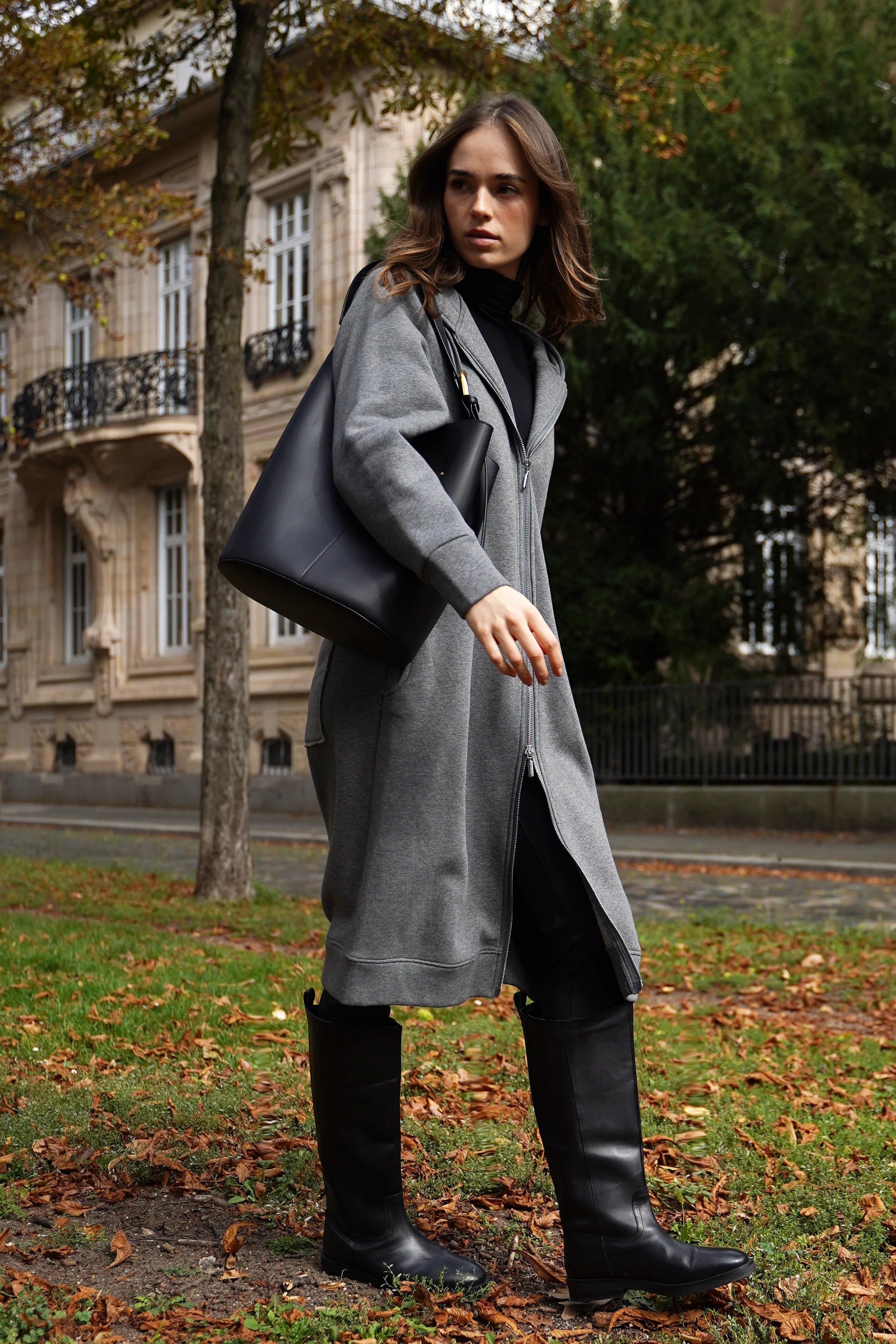 Woman wearing gray oversized MAY Longzip-Hoodie with two-way zipper and hood walking outdoors autumn