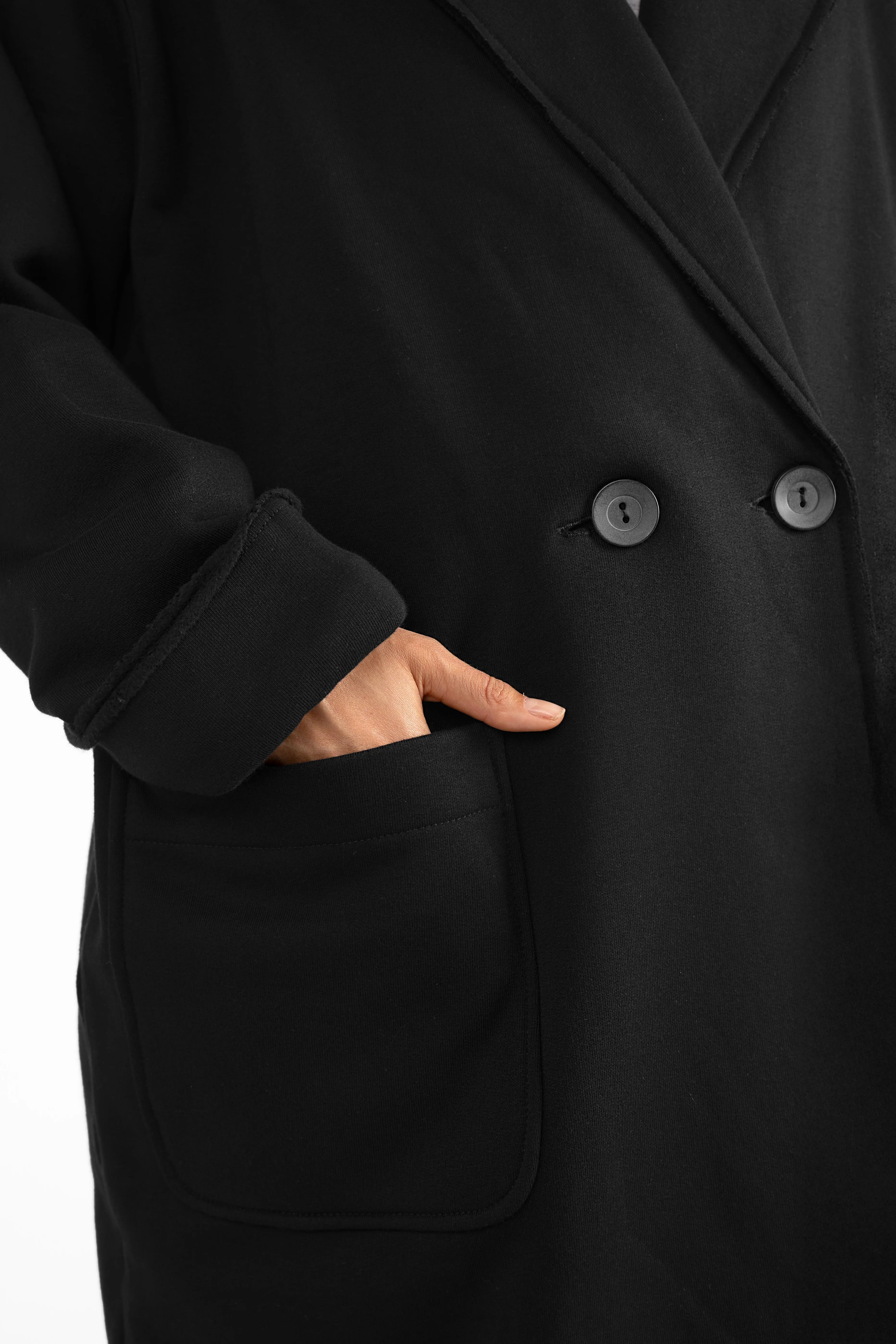 MONDY.K Oversize Sweatmantel black jersey coat with large pocket and cuffed sleeve detail