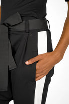 Close-up of black MYRAN Tapered Sweathose with white side stripes, tapered leg, and tied belt detail.