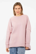 Woman wearing pink NAIRA Cozy Sweater with A-line silhouette and brushed cotton interior